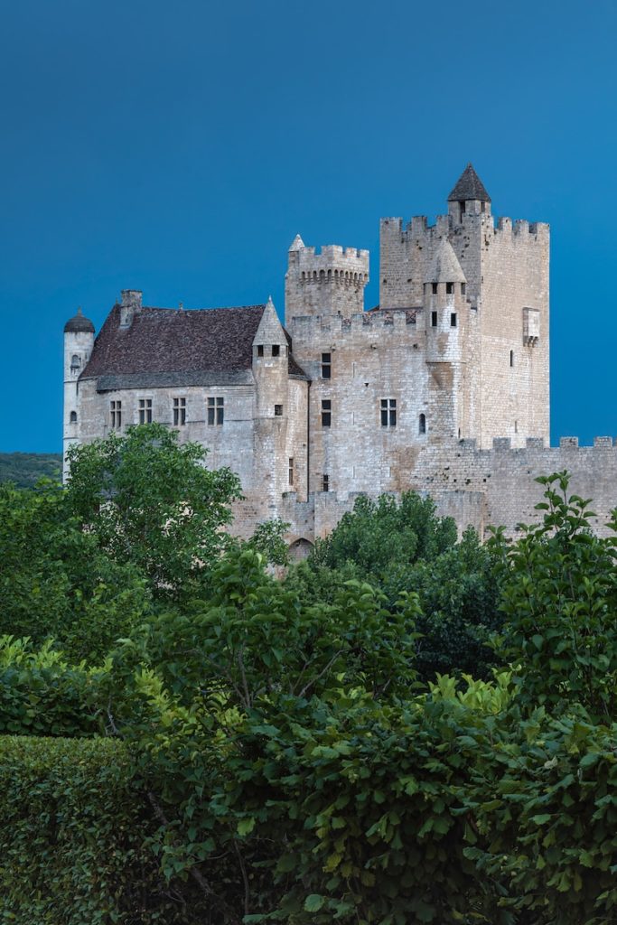 a castle with a clock on the front of it